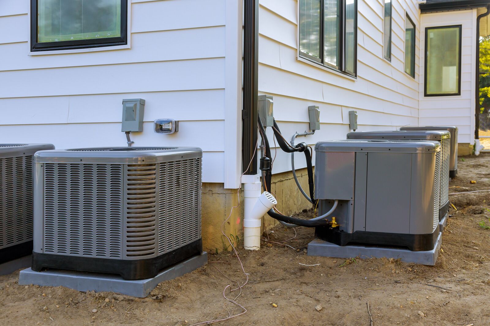 Outdoor AC units installed beside residential home